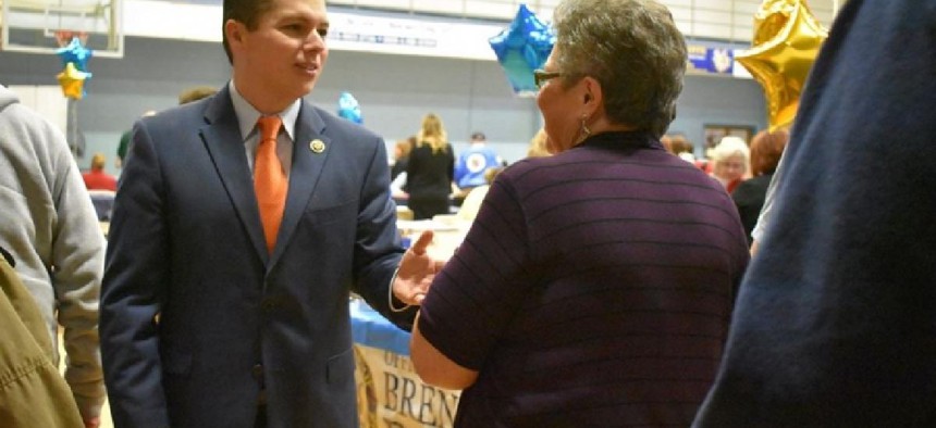 Congressman Brendan Boyle talks with a constituent at a Senior Expo last year – from Facebook