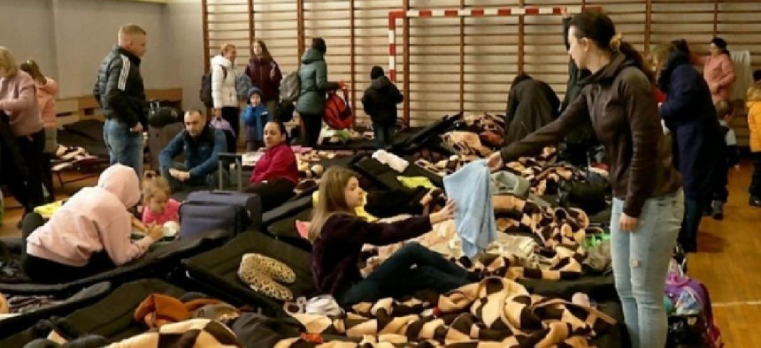 Ukrainian refugees are housed in a gymnasium in Poland.