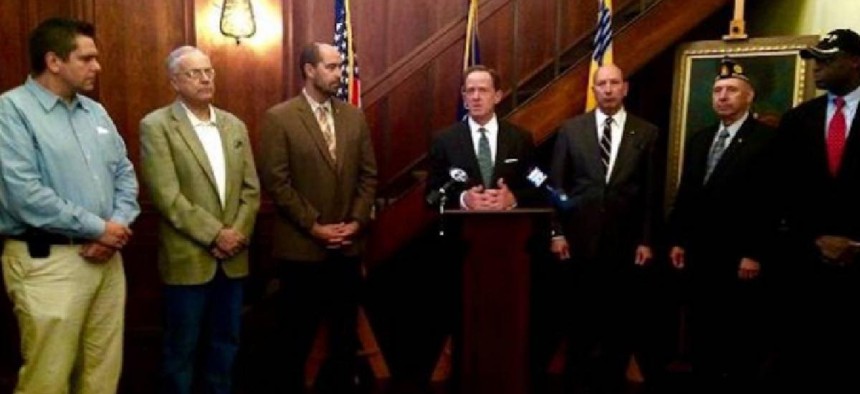 Scott Brown, left,  at a 2014 event with US Sen. Pat Toomey, center. From the Toomey website
