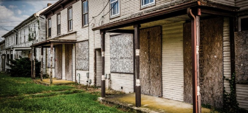 A row of abandoned houses in Bairs - Shutterstock