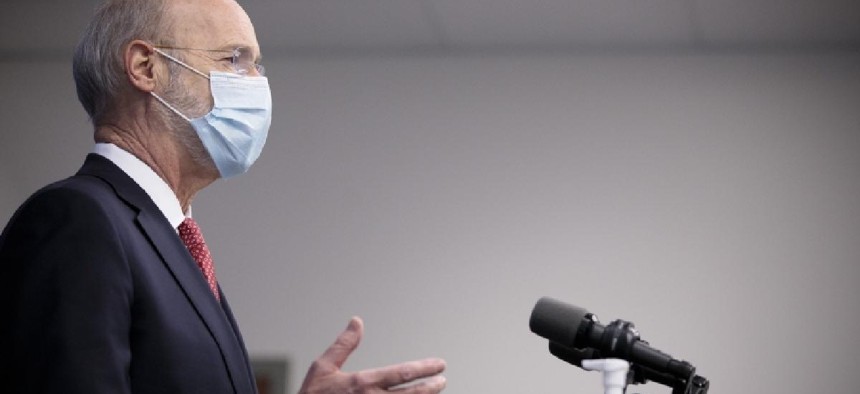 Gov. Tom Wolf wears a mask during a COVID-19 press conference