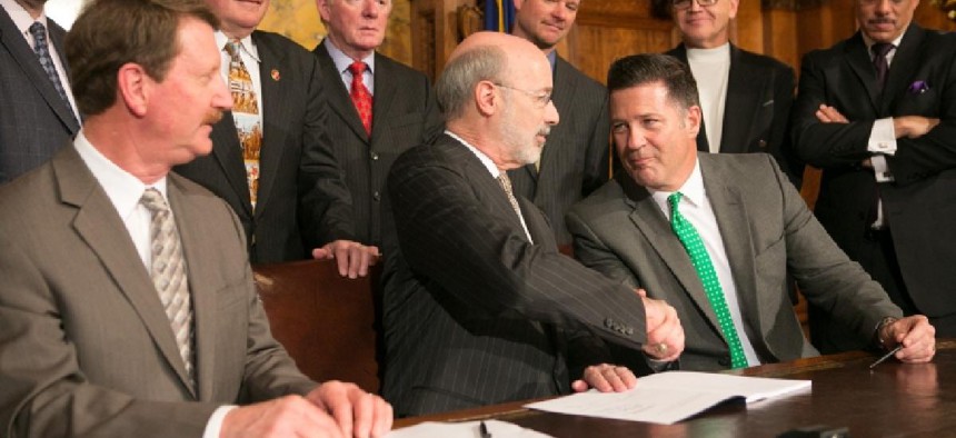 State Sen. Mike Regan (right) shakes hands with Gov. Tom Wolf
