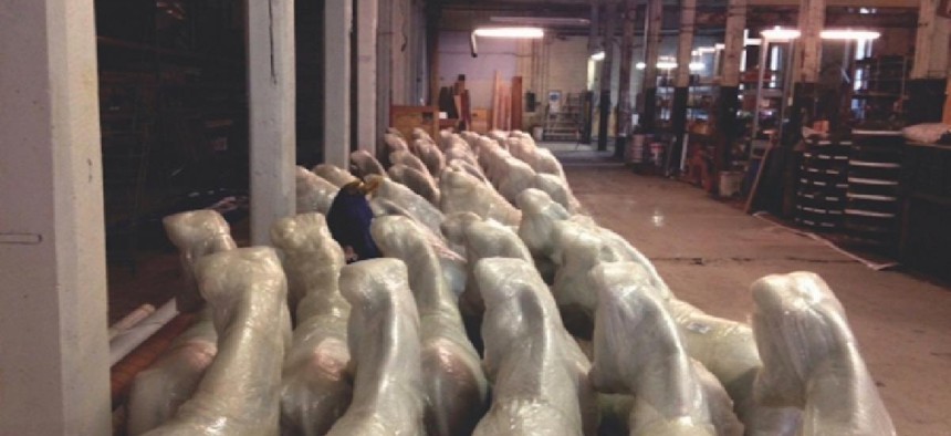 Fiberglas donkeys await delivery to their artists in a warehouse. Photo by Dave Heit