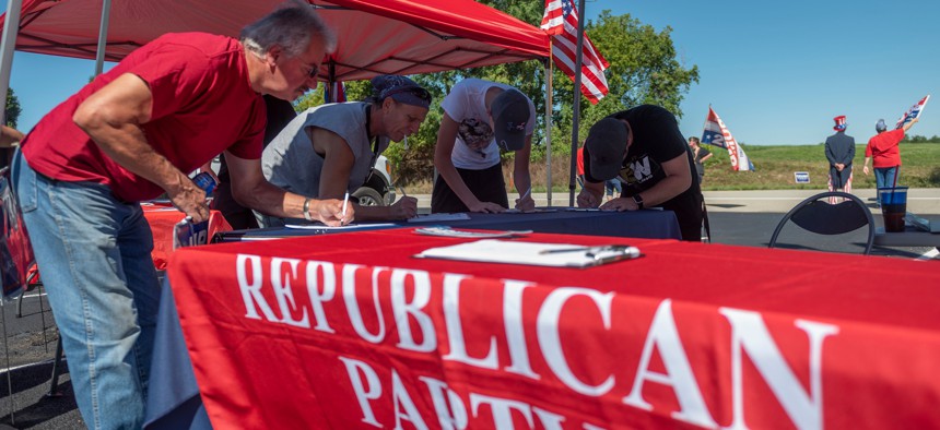 People register to vote during a Republican voter registration in Brownsville, PA.
