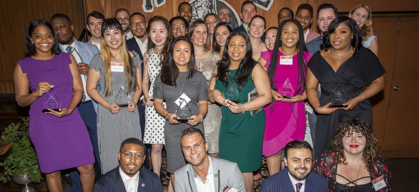 Forty Under 40 honorees pose with their awards at Heritage in Northern Liberties.