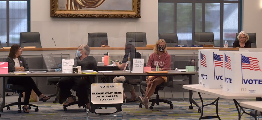 Election officials wait for voters at the West Chester Borough Hall during the May primary election.