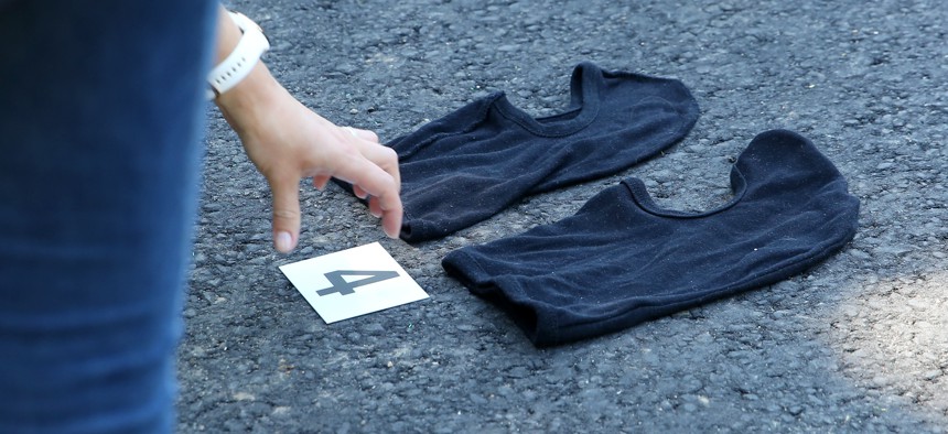 Police take a picture of two secured balaclavas. 