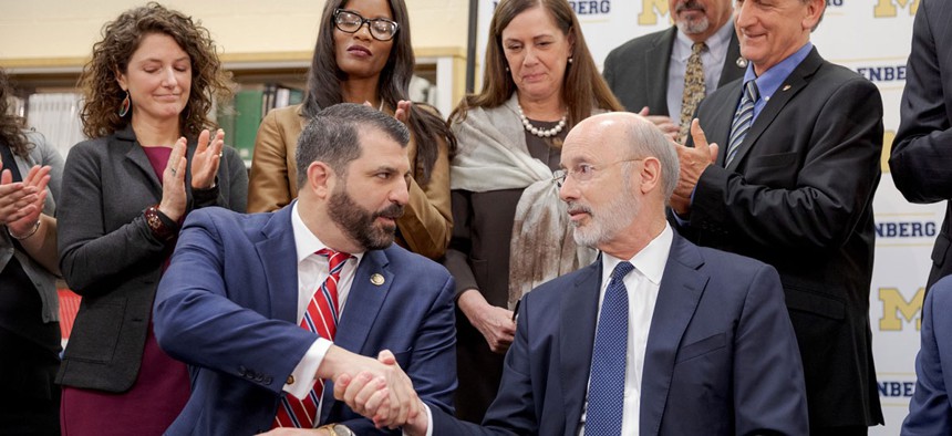 Gov. Tom Wolf shakes the hand of state Rep. Mark Rozzi in 2019 after signing statute of limitations reform legislation.
