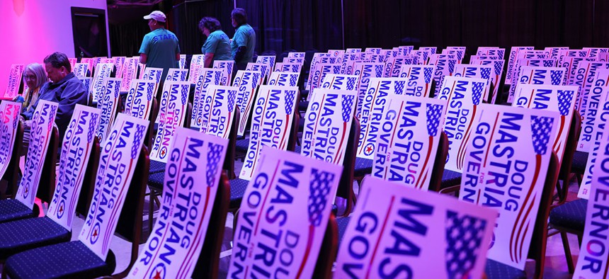 GOP gubernatorial candidate Doug Mastriano’s campaign signs are seen during a rally in May.