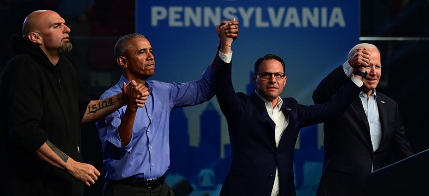 Democratic candidate for U.S. Senator John Fetterman, former President Barack Obama, Democratic candidate for Governor Josh Shapiro, and President Joe Biden raise their arms when departing after a rally at the Liacouras Center on November 5, 2022 in Philadelphia, Pennsylvania.
