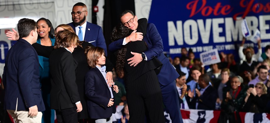 Democratic gubernatorial nominee Josh Shapiro embraces his family after giving a victory speech to supporters at the Greater Philadelphia Expo Center in Oaks on Election Day. 