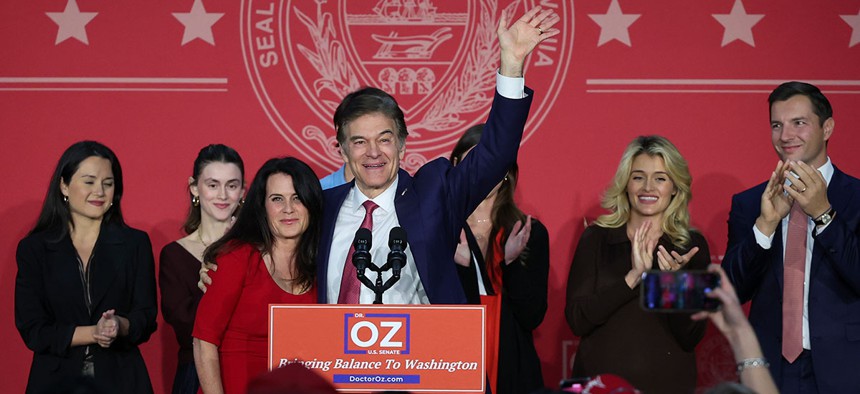 Dr. Mehmet Oz, joined by his wife, Lisa, speaks during an election night event at the Newtown Athletic Club Nov. 8 in Newtown.