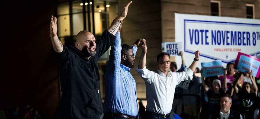 John Fetterman, Austin Davis and Josh Shapiro at a campaign rally in Newtown, Pa., on November 6, 2022.