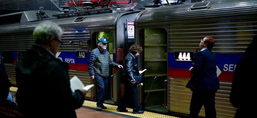 A SEPTA conductor stands on the balcony of a Silverliner IV Regional Rail train in Philadelphia.