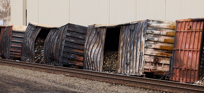 Charred train cars sit near railroad tracks in East Palestine, Ohio on Feb. 14, 2023.