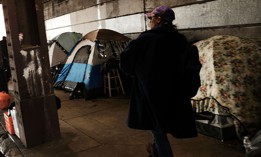 Heroin users gather under a bridge where many of them live with other addicts in the Kensington section of Philadelphia.