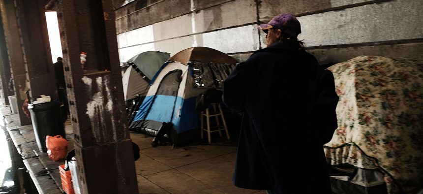 Heroin users gather under a bridge where many of them live with other addicts in the Kensington section of Philadelphia.