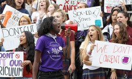A woman uses a megaphone to lead the students of Notre Dame High School, an all-girl's Catholic school in protest of the province's repeal of the sex-ed curriculum and replacement of it with an outdated version.