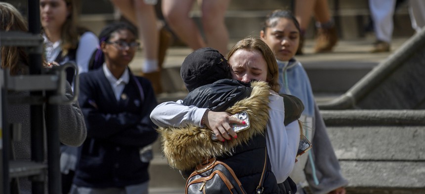 A student from Oakland Catholic High School receives comfort following the evacuation of her school after a call of an active shooter on March 29 in Pittsburgh.