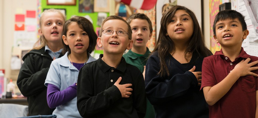 Students standing for the Pledge of Allegiance