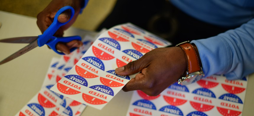 A volunteer cuts out " I VOTED TODAY" stickers in Philadelphia.