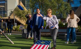 Christine Todd Whitman and fellow Forward co-chair Andrew Yang play cornhole at an event.