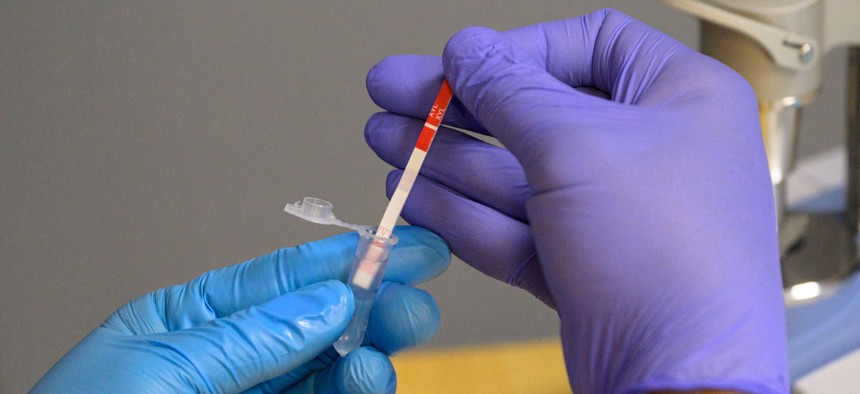 A field researcher with the New York City Department of Health tests a heroin sample for xylazine. 