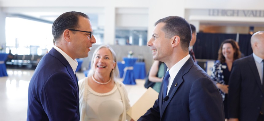 Gov. Josh Shapiro, left, welcomes U.S. Transportation Secretary Pete Buttigieg to Lehigh Valley International Airport on July 28. U.S. Rep. Susan Wild is in the background.