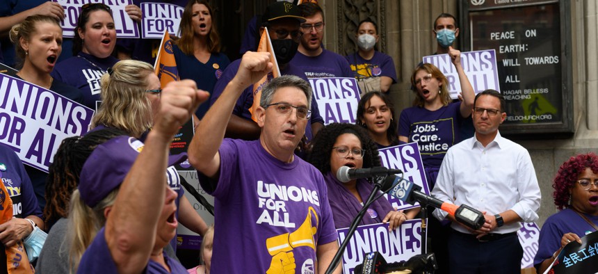 SEIU’s Neal Bisno, left, rallies with Gov. Josh Shapiro.