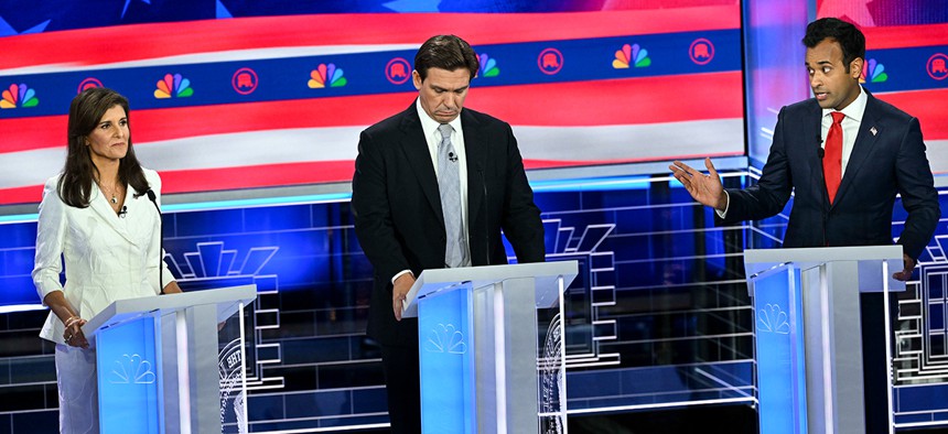 Businessman Vivek Ramaswamy talks to former United Nations Ambassador Nikki Haley, with Florida Gov. Ron DeSantis in the middle, during the Republican Presidential Debate at the Adrienne Arsht Center for the Performing Arts on November 8, 2023.