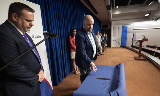 Department of State official Jonathan Marks oversees the department’s dice roll in May 2024.