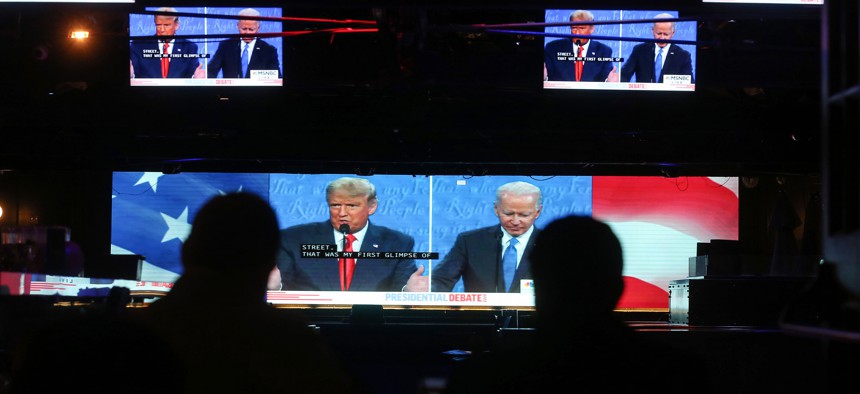 People watch a broadcast of the final debate between President Donald Trump and Democratic presidential nominee Joe Biden on October 22, 2020.