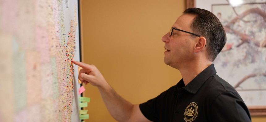 Gov. Josh Shapiro examines a map during a visit to Hummelstown.