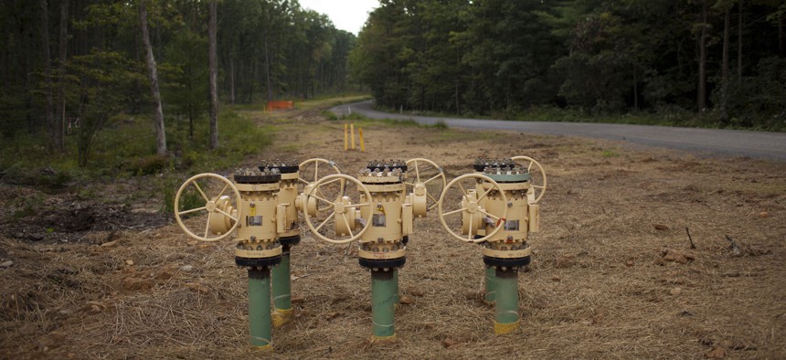 Large valves attached to a natural gas pipeline protrude along a reclaimed dirt track in Waterville.