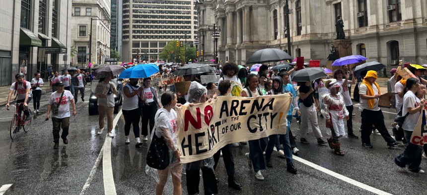 Protesters take to the streets around Philadelphia City Hall to oppose a proposed arena for the Philadelphia 76ers that opponents believe would endanger the city's beloved Chinatown.