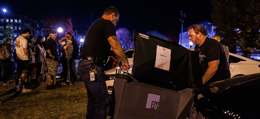 Workers deliver an additional voting machine to the polling location in the Banana Factory in the 3rd Ward of Bethlehem, Pennsylvania on November 5, 2024.