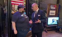 Pennsylvania Forward Party Chief Political Strategist Craig Snyder, right, talks with a supporter at the Forward Party