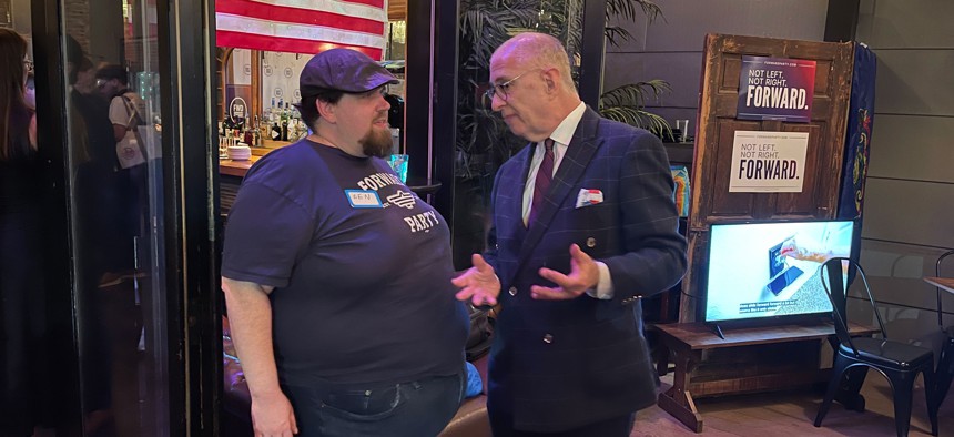 Pennsylvania Forward Party Chief Political Strategist Craig Snyder, right, talks with a supporter at the Forward Party