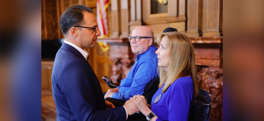 Gov. Josh Shapiro speaks with Eileen Miller at a bill signing ceremony in June 2024.