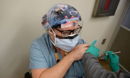 Nurse Anesthetist Sally Ollio receives a COVID-19 vaccine at the Pittsburgh VA Medical Center on December 17, 2020