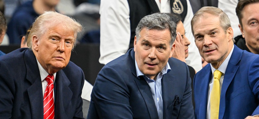 U.S. Sen. Dave McCormick, flanked by President Donald Trump and U.S. Rep. Jim Jordan, at the NCAA Division 1 wrestling finals in March.
