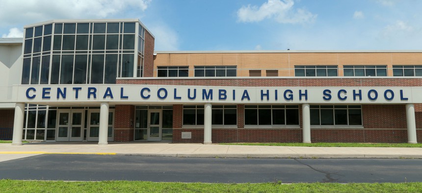An exterior view of Central Columbia High School in Bloomsburg and its 3.8 megawatt array with nearly 7,000 bifacial solar panels, which is estimated to offset 90% of the school district's annual power consumption.