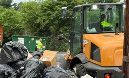 City workers clear the trash-strewn 5000 block of Wyalusing Avenue in West Philadelphia.