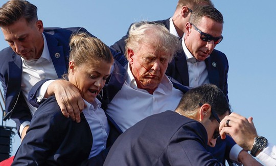 Then-candidate (now President) Donald Trump is rushed offstage during a rally on July 13, 2024 in Butler, Pennsylvania.