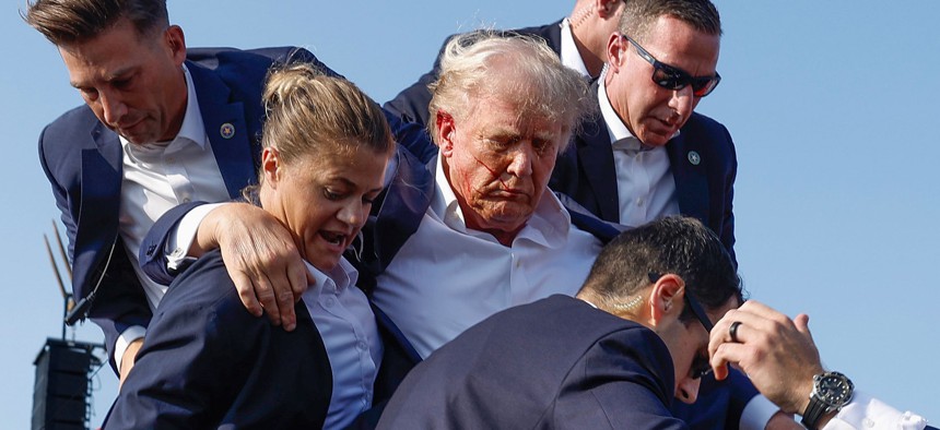 Then-candidate (now President) Donald Trump is rushed offstage during a rally on July 13, 2024 in Butler, Pennsylvania.