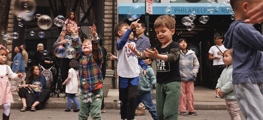 Children play on a Philadelphia street closed down as part of Center City District’s Open Streets initiative.