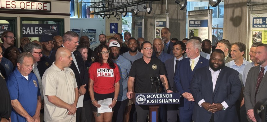 Gov. Josh Shapiro, at lectern, called for Harrisburg lawmakers to fund public transit agencies, including SEPTA, across the state.