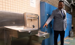 Pittsburgh Public Schools Environmental/Sustainability Manager Sanjeeb Manandhar at a lead-filtering water station at Dilworth Elementary School.