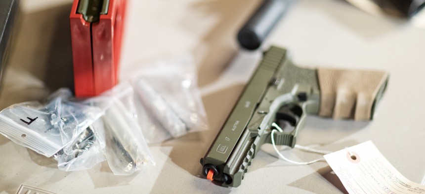 Firearms displayed at a 2019 press conference focused on unserialized “ghost guns.”