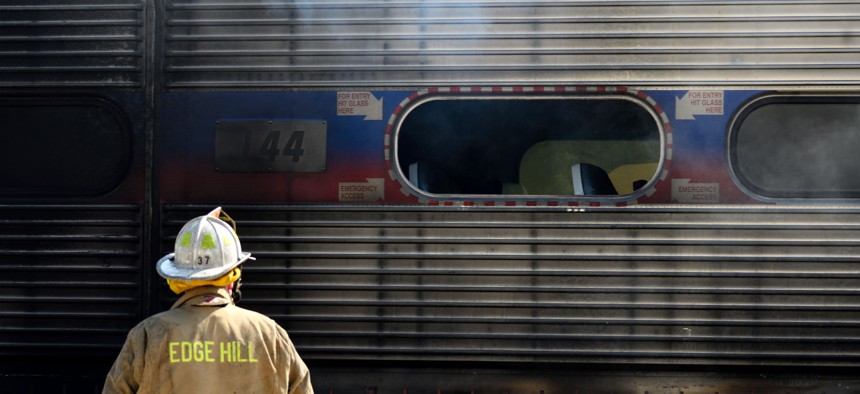 Firefighters battle a fire on a commuter train, at SEPTA’s Glenside, PA station on August 29, 2018